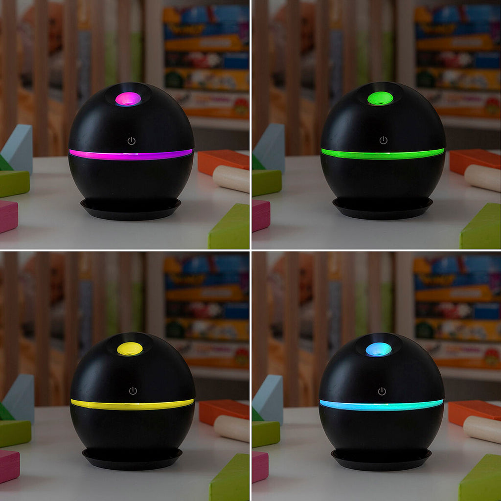 Difusor de aroma ultrasónico con iluminación LED multicolor para relajación y bienestar en escritorio o dormitorio.